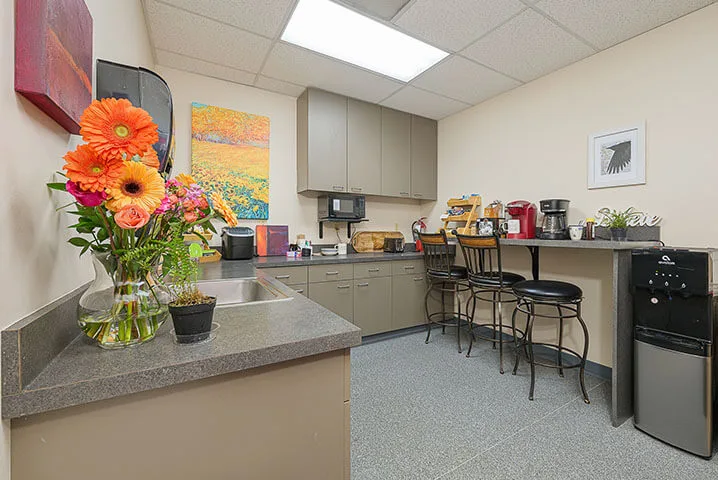 Membership includes water, coffee and tea. Kitchen space with fridge.